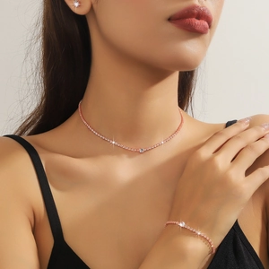 Rose gold jewelry set with tennis chain necklace and bracelet featuring round zircon stones