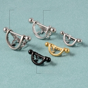 Size comparison of stainless steel nipple rings in black, gold, and silver finishes