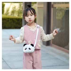 Detailed view of plush panda shoulder bag with adjustable strap on a child model