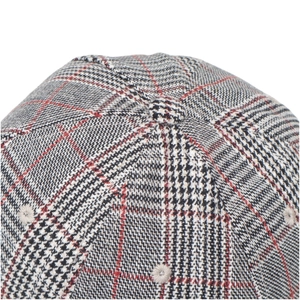 Detailed top view of a houndstooth baseball cap with red stripes and embroidered eyelet