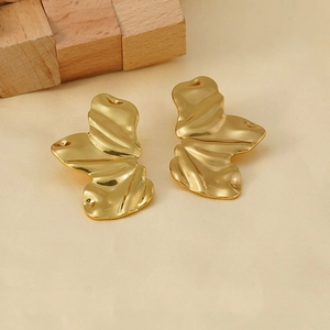 Irregular 18K gold plated stainless steel wave earrings on a minimalist background