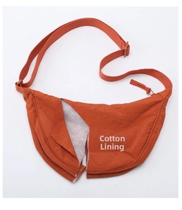 Detail of cross-body bag featuring cotton padded interior for extra softness and volume