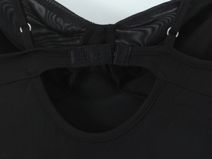 Detail of back hook-and-eye closure and mesh splicing on sexy black slim fit dress