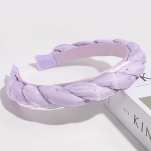 Detailed macro of a purple braided headband with sparkling rhinestone embellishments