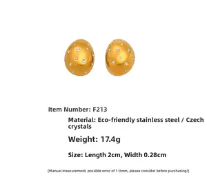 Close-up of gold-plated stainless steel oval earrings with shimmering Czech rhinestones