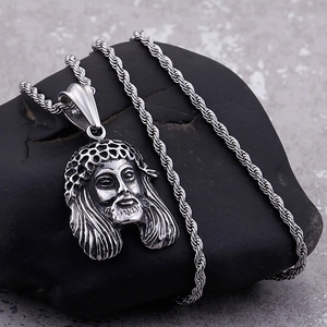 Vintage silver Jesus head pendant with thorn crown on twist chain over dark stone