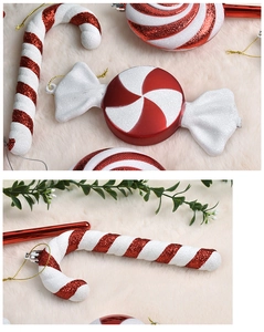 Macro detail of red and white glitter candy cane ornaments with golden hanging strings