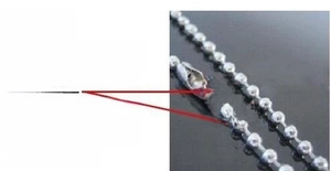Macro detail of the ball chain necklace connector showing the easy plug-in locking mechanism