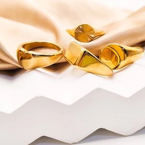 Set of four 18K gold plated stainless steel rings featuring heart and geometric designs