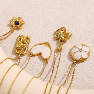 Detail of 18K gold-plated stainless steel necklaces with star, moon and heart pendants