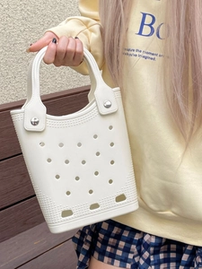 White EVA perforated beach tote bag held by a model for summer vacation use