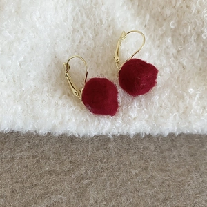 Vue détaillée de boucles d'oreilles en peluche bordeaux avec crochets dorés chics