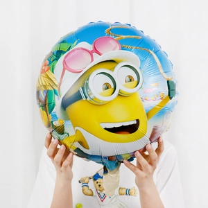 Detail of round foil balloon featuring a Minion beach scene for baby shower parties