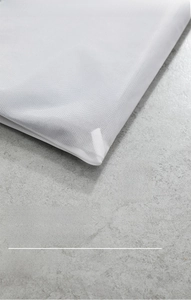 Detail showing reinforced interior seams and fine mesh edges for durable laundry bag