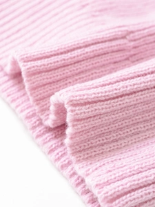Close-up of pink ribbed knit fabric texture showing high elasticity and soft weaving detail
