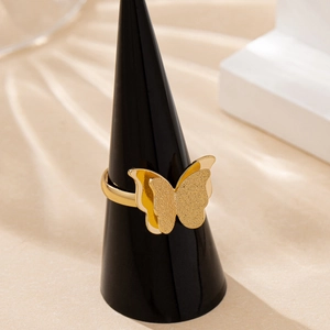 Elegant gold double-layered butterfly ring with frosted finish on a black cone stand