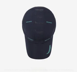 Top view of navy quick-dry sports cap showing laser-cut vent holes and mesh panels