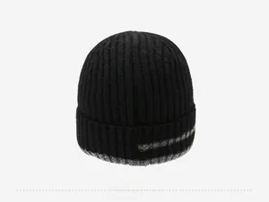 Detail view of the back of a black ribbed knit beanie with grey stripe pattern