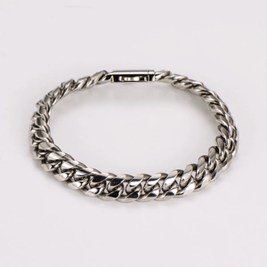 Macro shot of silver stainless steel Cuban link bracelet with a secure box clasp