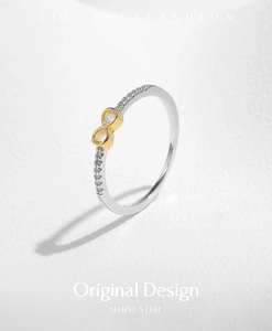 Macro shot of silver and gold infinity ring with shimmering zircon stones inlay