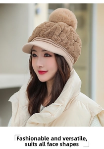 Close-up of stylish khaki plush winter hat with large faux fur pompom and visor detail