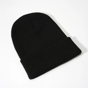 Detailed close-up of the knitted texture and cuffed hem on a classic black beanie hat