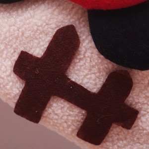 Macro shot of plush Christmas stocking fabric with detailed stitching and felt patches