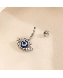 Close-up of evil eye navel ring with blue stone and crystals on stainless steel