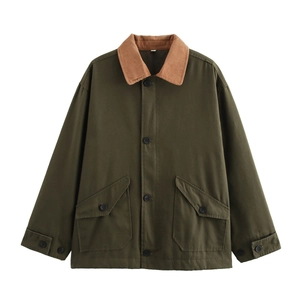 Macro detail of dark olive jacket with corduroy collar and buttoned front pockets