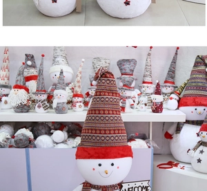 Close-up of plush Christmas snowman and Santa dolls with a Welcome sign for holiday decor