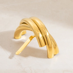 Polished 18K gold-plated chunky multi-layer U-shaped hair ring jewelry shown on stone base