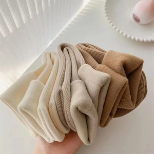 Close-up of thick knitted snow socks showing ribbed texture in earth tone colors