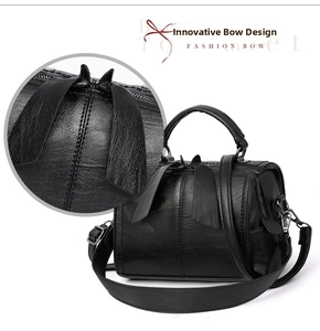 Close-up of litchi texture PU leather Boston bag with fashion bow and handles