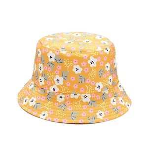 Yellow floral reversible bucket hat with pink and white flowers for sun protection