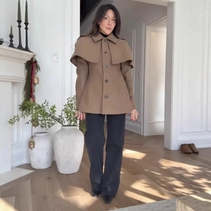 Elegant camel short wool cape coat with lapel collar and waist-defining silhouette