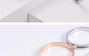 Detail of rose gold and silver titanium steel bracelets with black inlay and crystals