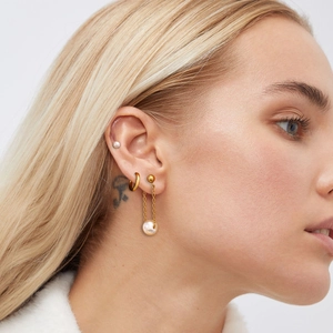Three-pair set of gold stainless steel hoop earrings with elegant pearl drop charms