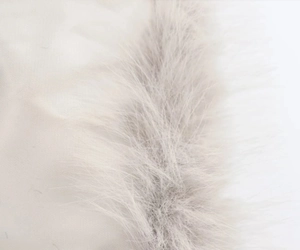 Macro shot showing soft faux fur material and high-density base fabric of the beige jacket