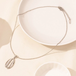 Detail of silver stainless steel starfish shell pendant with fine textured grooves