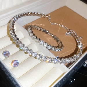 Close-up of silver jewelry set with necklace bracelet and earrings in a gift box