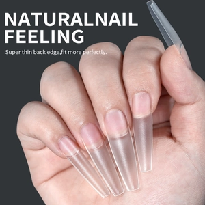 Macro detail of long coffin false nail tips with super thin back edge for natural fit