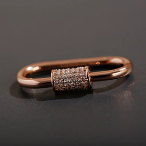 Macro shot of rose gold screw clasp pendant with micro-pave crystals detail