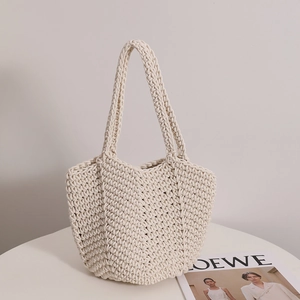 Vintage cotton crochet shoulder bag with hand-woven texture for beach and vacation use