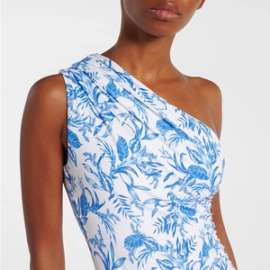Detail of one-shoulder swimwear featuring blue floral print and pleated shoulder strap