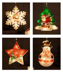 Detail of warm LED Christmas hanging lights featuring snowflake, tree, and star shapes