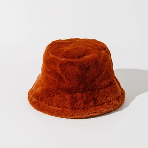 Close-up of caramel faux fur bucket hat showing soft plush texture and warm material