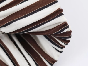 Macro detail of the woven striped fabric texture in brown black and white pattern