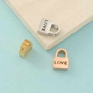 Detailed macro view of heart lock charms in silver, gold, and rose gold finishes