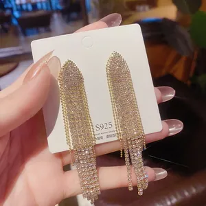 Detail shot of long tassel earrings with S925 silver needles and sparkling rhinestones