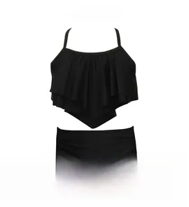 Detail of black two-piece swimwear with ruffled layers and high-waisted bikini bottoms